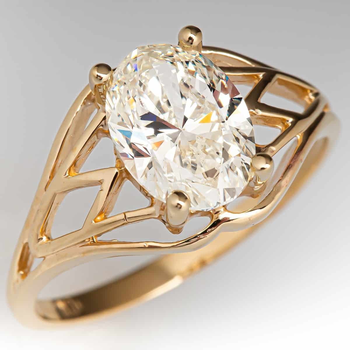1.5 ct Oval SI2 M Color in open shoulder yellow gold setting 1.5 ct oval SI2 M diamond in open shoulder yellow gold setting