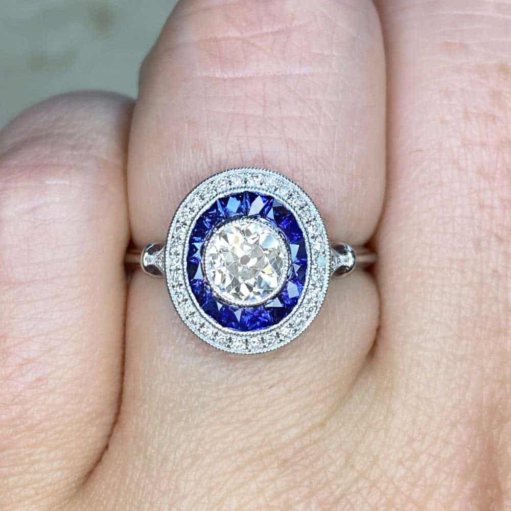 Bezel set 0-66 K color VS with blue sapphire halo Bezel set 0-66 K color VS with blue sapphire halo